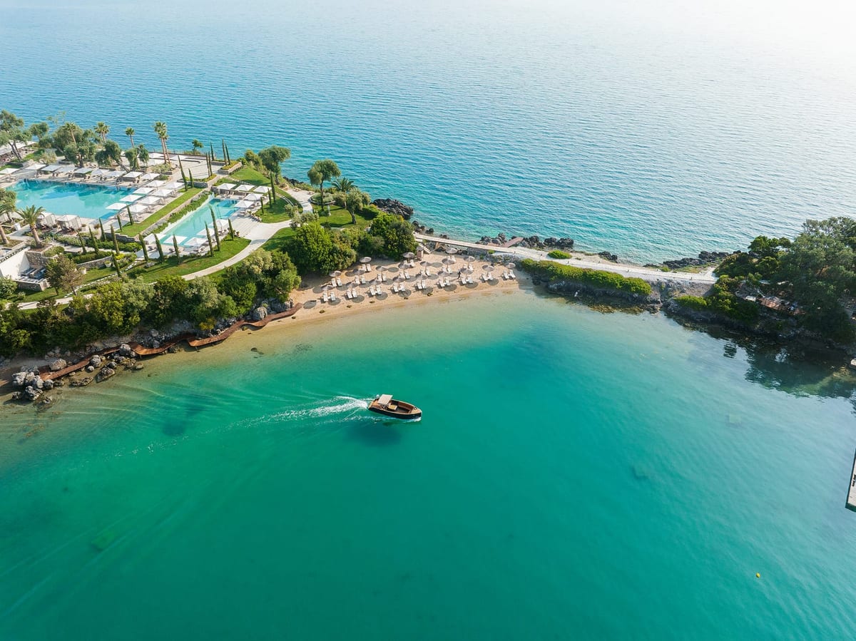 Sandy cove and turquoise water at Grecotel Corfu Imperial